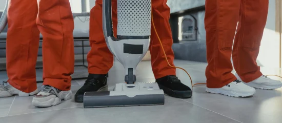 Professional cleaners in Melbourne using a vacuum machine for carpet cleaning services.