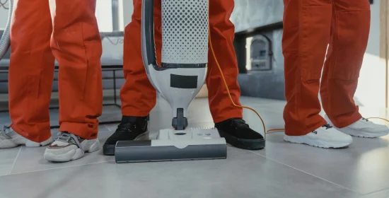 cleaning-services-melbourne Professional cleaners in Melbourne using a vacuum machine for carpet cleaning services.