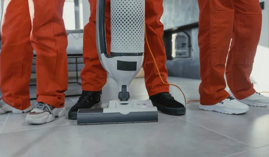 cleaning-services-melbourne Professional cleaners in Melbourne using a vacuum machine for carpet cleaning services.